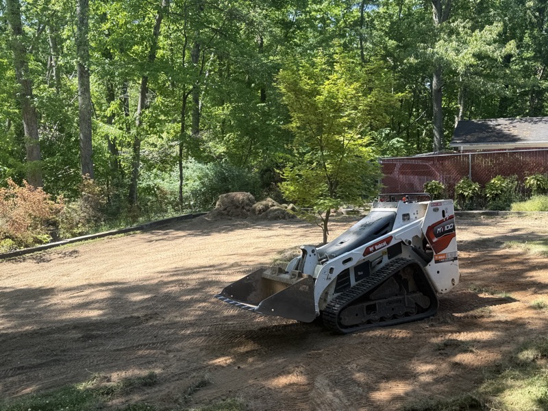 Track loader on a freshly graded backyard