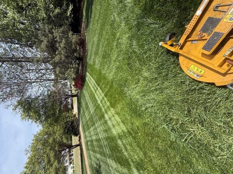Zero-turn mower on a freshly striped lawn